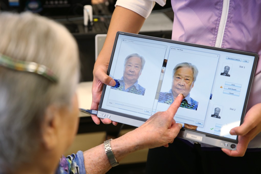 An elderly Hongkonger chooses the picture for her replacement smart ID card in June 2019. Photo: Winson Wong