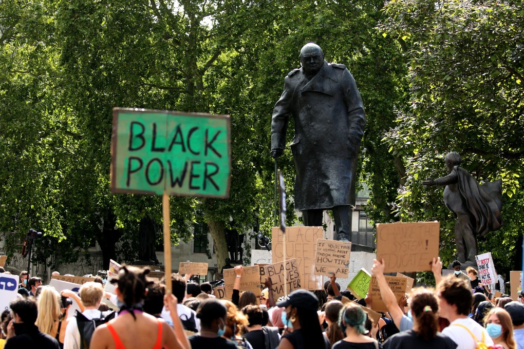 Protesters at a Black Lives Matter rally gather around the statue of former British prime minister Winston Churchill at Parliament Square on June 21. While Churchill is remembered for leading the country through World War II, critics have highlighted some of his disturbing comments on race and decisions that had devastating consequences in British colonies. Photo: Anadolu Agency via Getty Images