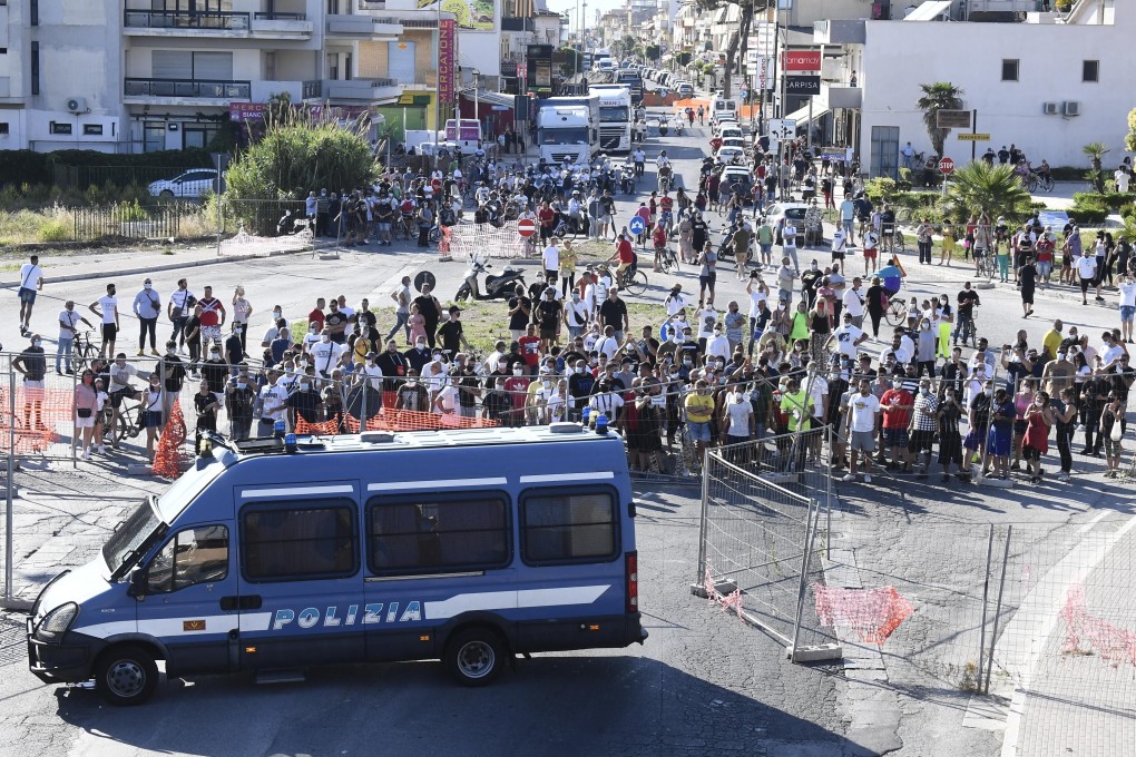 Riot police deployed as tensions erupt at coronavirus-hit housing ...
