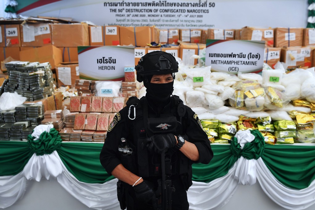 A Thai policeman with confiscated narcotics to be incinerated. Photo: AFP