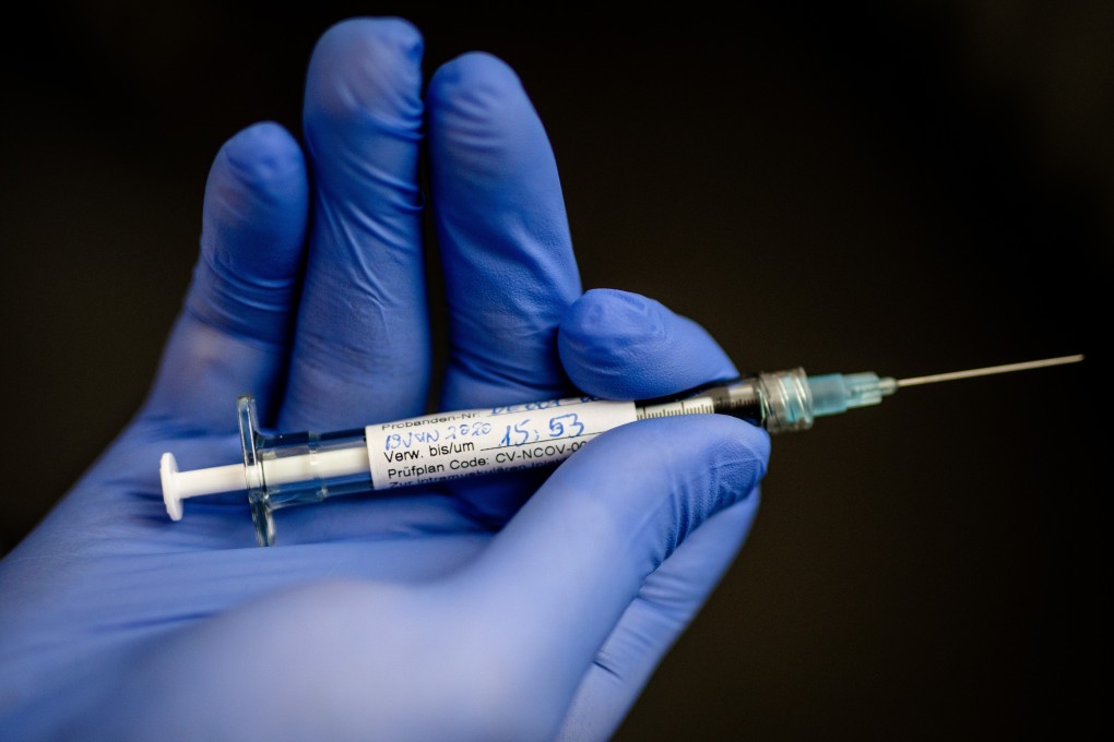 An employee of the German biopharmaceutical company CureVac, holds a syringe with which the first test person was injected with a possible coronavirus vaccine, at the Institute of Tropical Medicine in the University Hospital of Tuebingen. Photo: dpa