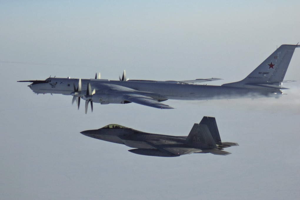 A Russian Tu-142 maritime reconnaissance aircraft, top right, is intercepted near the Alaska coastline. Photo: North American Aerospace Defense Command via AP