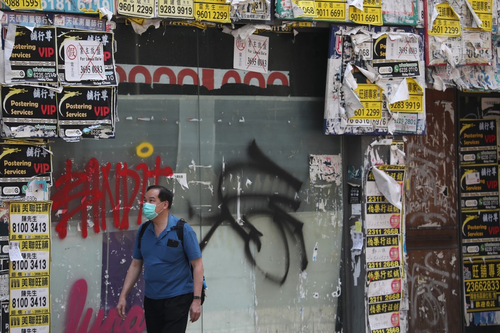 A man walks past a closed retail store in Wan Chai on April 30. Over 2,000 Hong Kong companies filed for bankruptcy in May. Photo: Xiaomei Chen