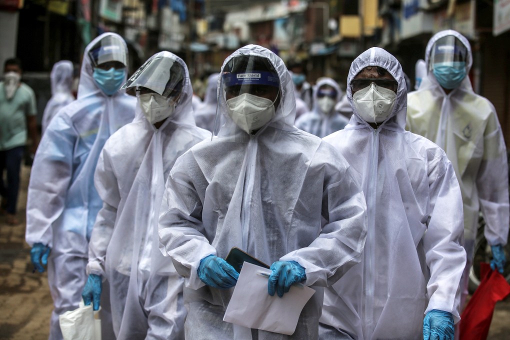 Indian health workers wearing personal protective equipment arrive at a coronavirus hotspot in Mumbai. Photo: EPA