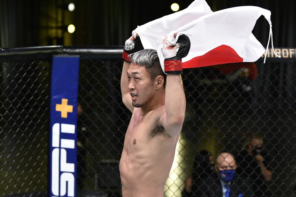 Takashi Sato celebrates with the Japanese flag after defeating Jason Witt during UFC Fight Night at the UFC APEX. Photos: USA TODAY Sports