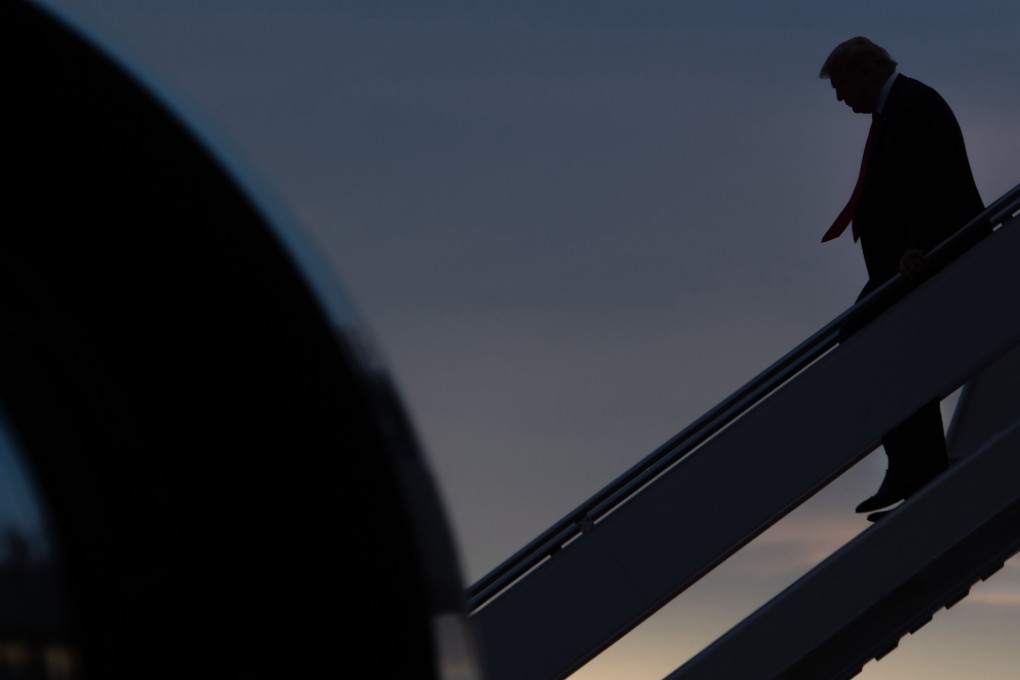 US President Donald Trump disembarks from Air Force One. Photo: AFP