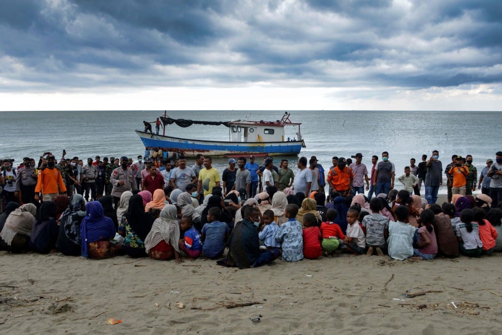 Evacuated Rohingya people from Myanmar sit on the shorelines of Lancok village, in Indonesia's North Aceh Regency after their rescue. Photo: AFP