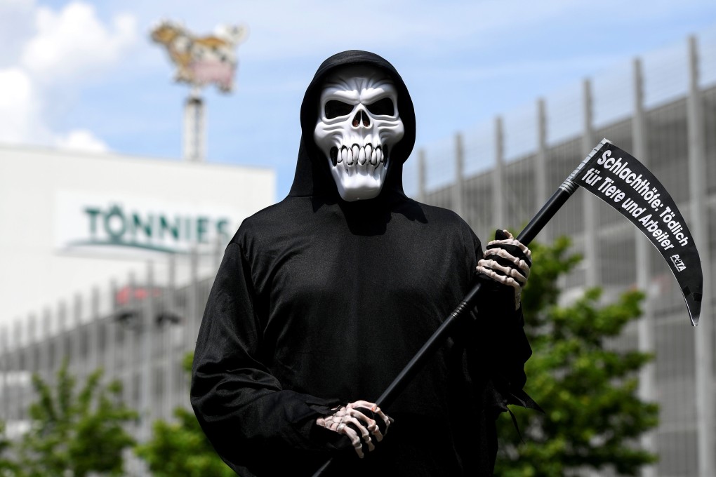 A member of PETA (People for the Ethical Treatment of Animals) dressed as a grim reaper outside the headquarters of abattoir company Toennies, after an outbreak at a huge slaughterhouse. Photo: AFP
