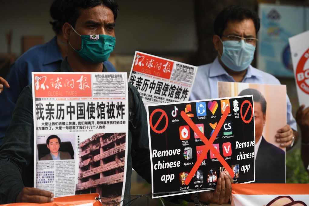 Members of the organisation Working Journalists of India hold placards urging citizens to remove Chinese apps and stop using Chinese products during a demonstration in New Delhi on June 30. Photo: Agence France-Presse