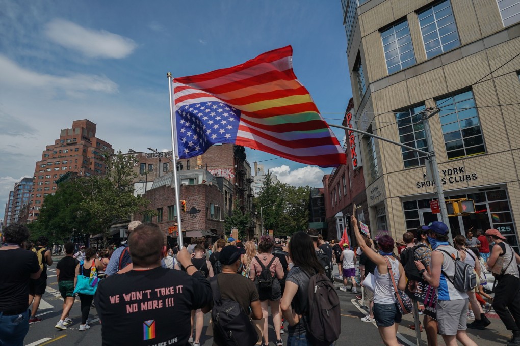 A man carries the American flag upside-down during the Queer Liberation March in New York on Sunday. Photo: AFP