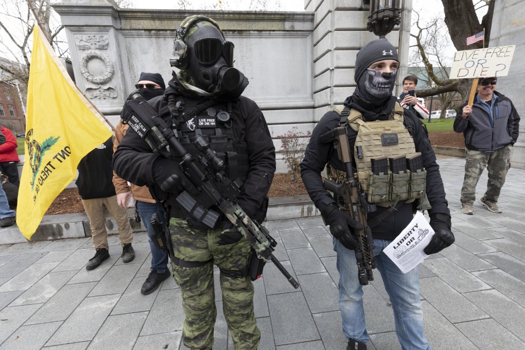 Members of the Boogaloo Movement, attend a demonstration against the lockdown over concern about Covid-19 at the State House on Saturday, April 18, 2020. Photo: AP