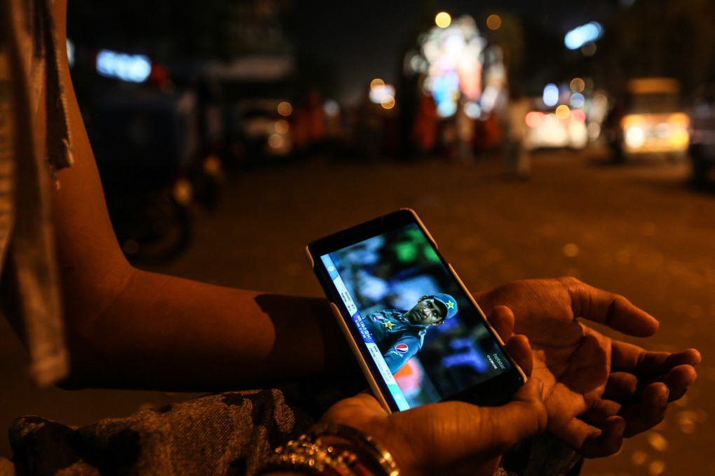 An Indian youngster watches a cricket match on his smartphone. China’s two largest telecoms equipment vendors, Huawei Technologies and ZTE Corp, could be shut out of the roll-out of superfast 5G mobile networks in India amid rising tensions between the two countries. Photo: EPA-EFE