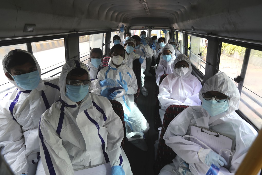 Health workers in India travel on a bus to conduct a free medical checkups in Mumbai. Coronavirus cases are surging in India, with over 600,000 infections. Photo: AP