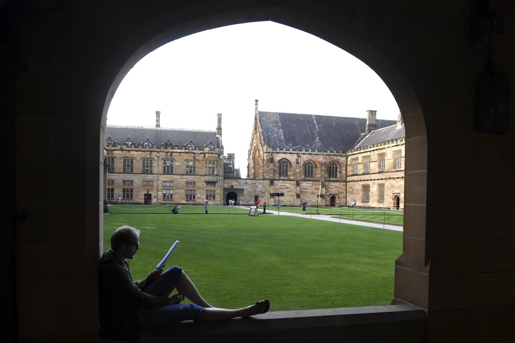 A student reads while sitting on a ledge at the Quadrangle of the University of Sydney, Australia. Photo: AP