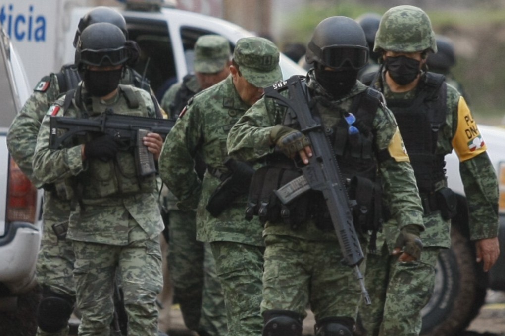 Troops at the scene of the massacre. Photo: AP
