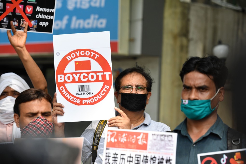 Protesters hold placards urging Indian citizens to remove Chinese apps and stop using Chinese products during a demonstration in New Delhi on June 30. Photo: AFP