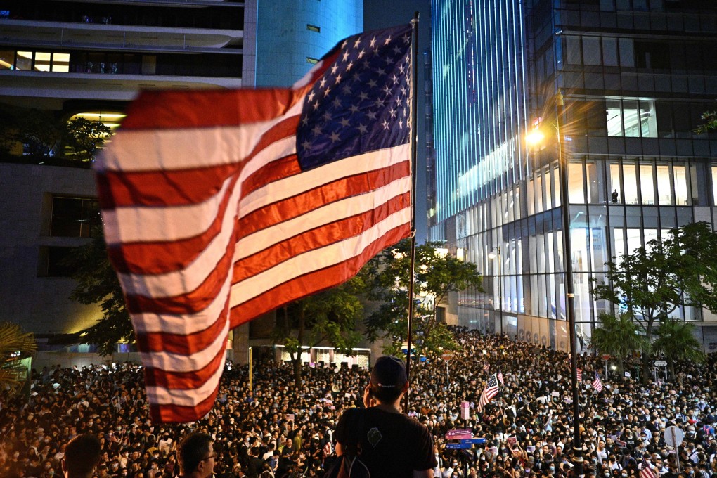 An American flag is waved during an October 2019 rally in Hong Kong. Photo: AFP