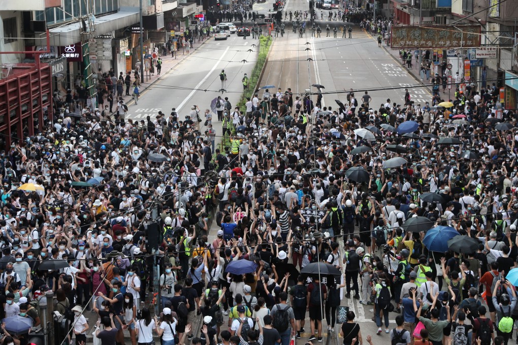 Protesters on Hennessy Road in Causeway Bay defy a police ban on the first full day of the new legislation coming into effect. Photo: Sam Tsang