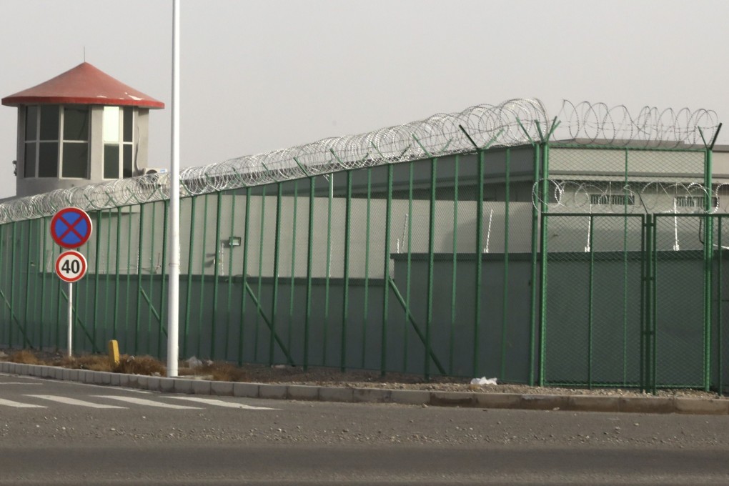 A guard tower and barbed wire fence surround a detention facility in Xinjiang in December 2018. Photo: AP