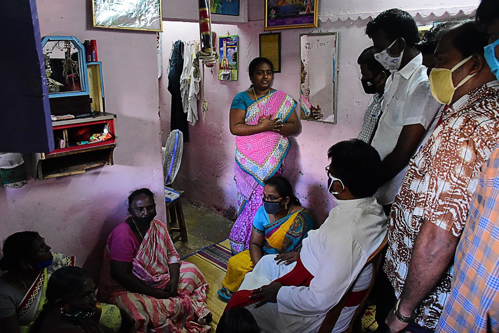 A church priest consoles family members of Jayaraj, 58, and son Bennicks Immanuel, 31, who died after allegedly being tortured at the hands of police in Sathankulam, Tamil Nadu on June 28. Photo: AFP