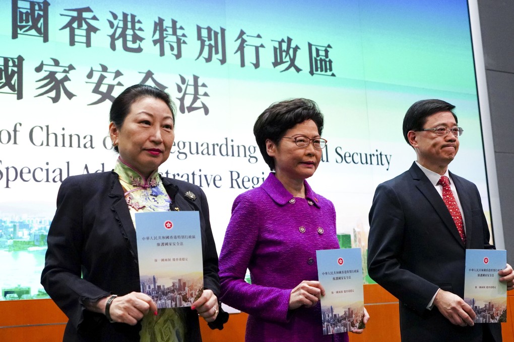 Meeting the press to discuss the new national security law are, (from left) Secretary for Justice Teresa Cheng, Chief Executive Carrie Lam and Secretary for Security John Lee Ka-chiu, at the Hong Kong government headquarters on July 1. Photo: Robert Ng