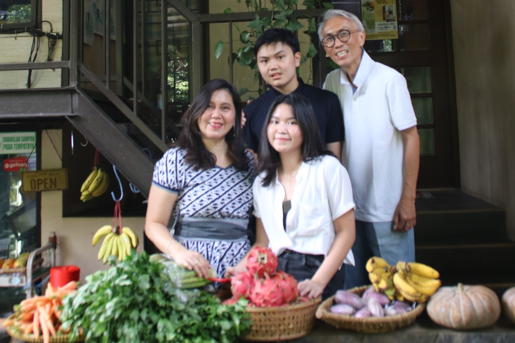 Emilia Nursanti Wibisono, known locally as Santi, her children Kay and Verena, and husband Satrio Wibisono, in front of their business, Organik Klub in Jakarta, Indonesia. Photo: Ade Mardiyati