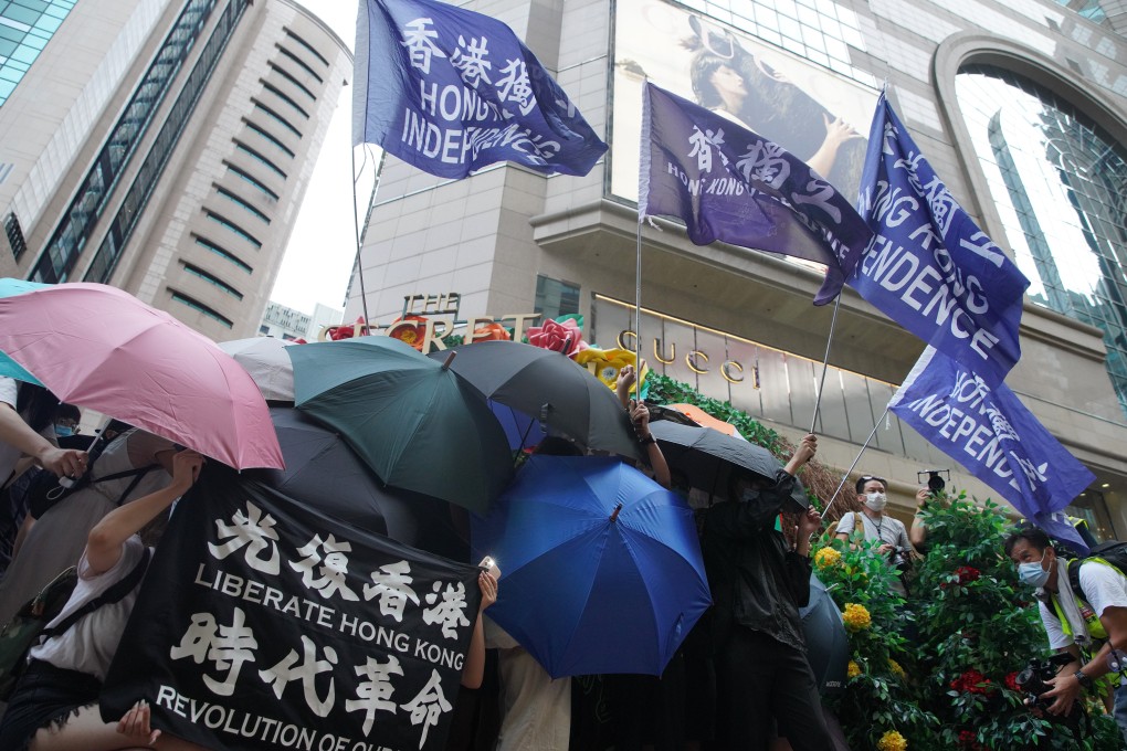Protesters wave Hong Kong independence flags outside the Times Square shopping centre during a demonstration in Causeway Bay on July 1. Photo: Winson Wong
