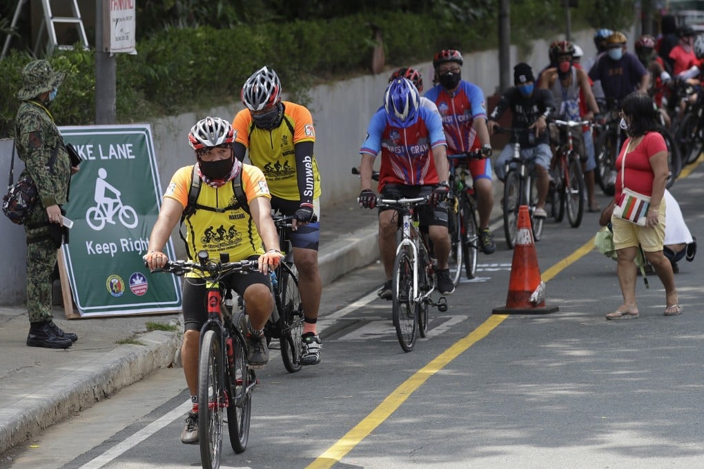 Cyclists wearing protective masks ride along a newly opened bike lane in San Juan city, Metro Manila, in observance of World Bicycle Day on June 3, 2020. Several cities have opened bicycle lanes as people use different ways of commuting while public transport remains limited to prevent the spread of Covid-19. Photo: AP
