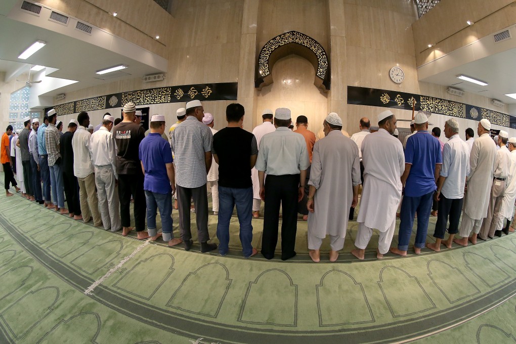 Muslims say prayers at the Masjid Ammar and Osman Ramju Sadick Islamic Centre in Wan Chai, Hong Kong. Its imam has written a book that explains Islam to non-Muslims and recounts the history of Muslims in the city. Photo: K.Y. Cheng