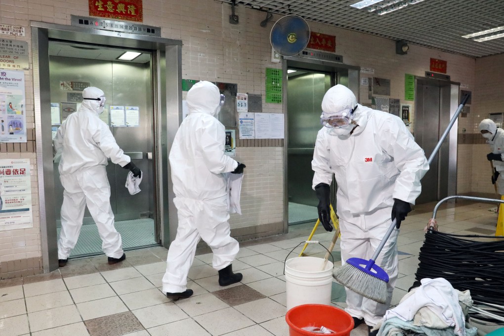 Workers disinfect a public housing block in Yuen Long where the male patient had previously lived. Photo: Dickson Lee