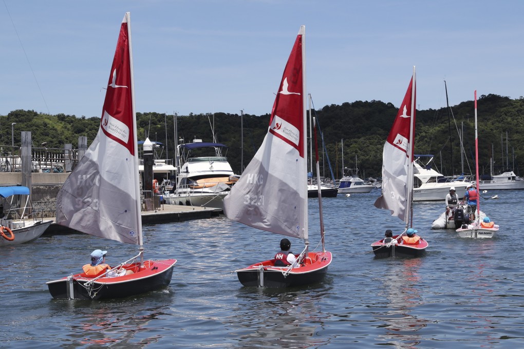 Kids head out to the water in their dinghies as part of the Sailability and Sun Hung Kai/Scallywag partnership. Photo: Edmond So