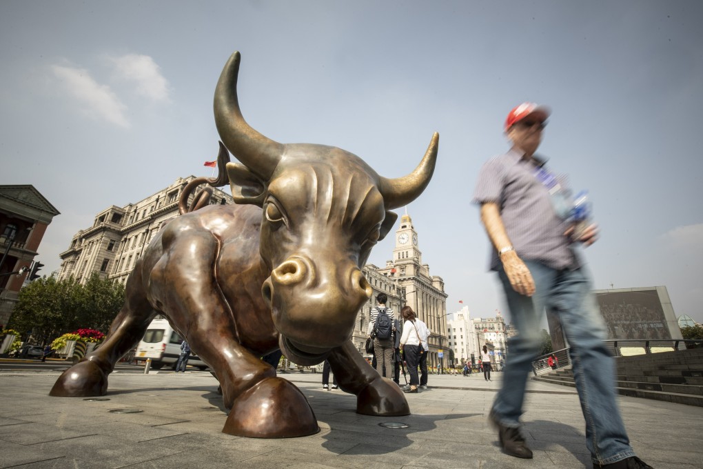 A pedestrian walks past the Bund Bull statue in Shanghai. Chinese stocks made rapid gains on Monday. Photo: Bloomberg