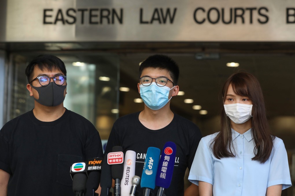 Opposition activists (from left) Ivan Lam, Joshua Wong and Agnes Chow outside Eastern Court. Photo: Sam Tsang