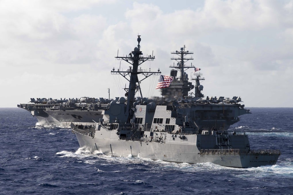 The guided-missile destroyer USS Ralph Johnson in formation with the aircraft carrier USS Nimitz during dual carrier operations with the Nimitz and Theodore Roosevelt Carrier Strike Groups on June 23. Photo: US Navy