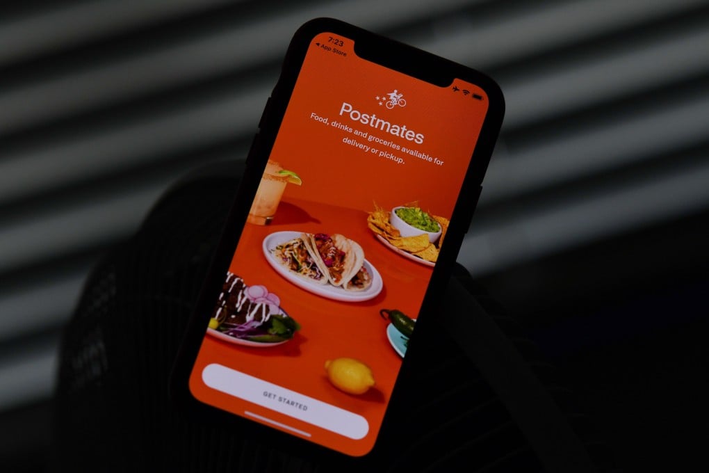 Food delivery app Postmates is seen on a smartphone screen. Photo: Agence France-Presse
