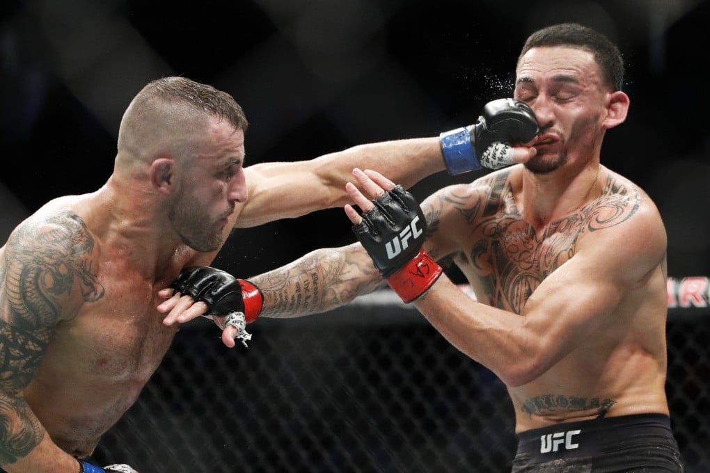 UFC featherweight champion Alexander Volkanovski hits Max Holloway in their featherweight title bout at UFC 245 in Las Vegas, Nevada, in December 2019. Photo: AP