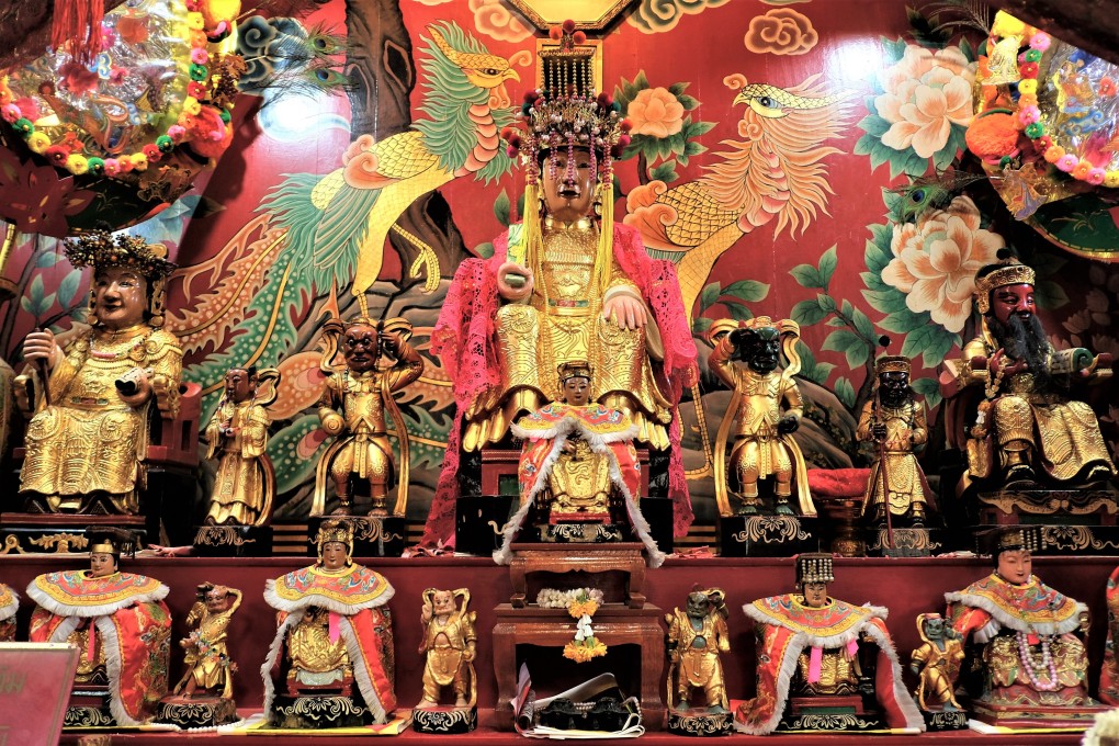 The altar of the Chao Mae Thap Thim shrine in Bangkok, Thailand. A sacred statue of the sea goddess Mazu has pride of place on an altar among various other deities and divine guardians. Photo: Tibor Krausz