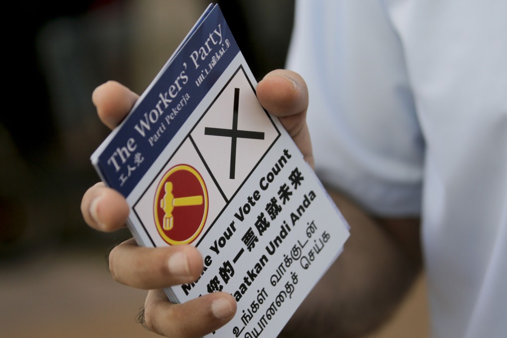 A member of Singapore’s Worker's Party handing out flyers before the elections. Photo: EPA