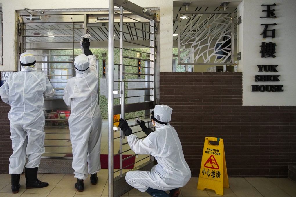 Workers disinfect Yuk Shek House in Ping Shek Estate. Photo: Winson Wong