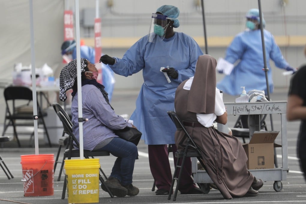 A health care worker administers a Covid-19 test in Homestead, Florida, on Monday. Photo: AP