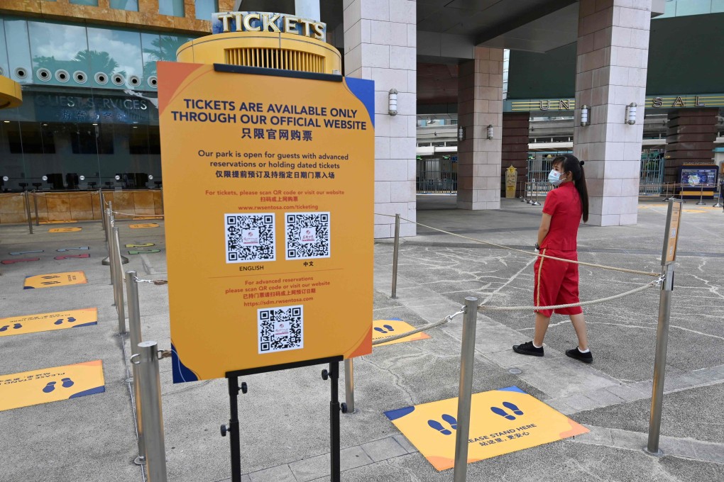 A staff member waits for visitors to the Universal Studios Singapore theme park on the resort island of Sentosa. Photo: AFP