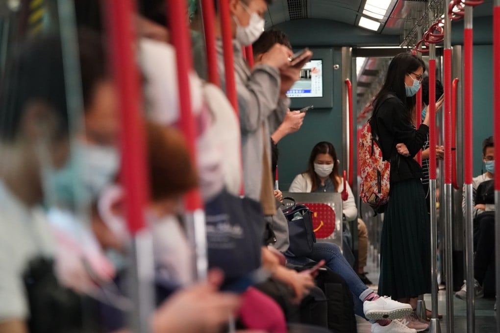 Commuters in face masks going to work via the East Rail Line. Photo: Felix Wong