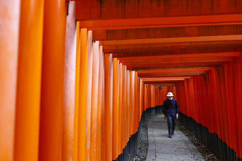 A man wearing a face mask at the near-deserted Fushimi Inari Taisha shrine in Kyoto, amid continuing worries over the coronavirus pandemic. Photo: Kyodo
