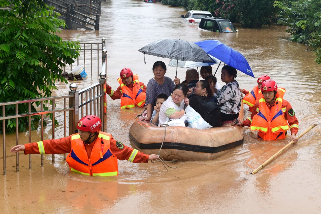 Rescuers tow a raft filled with evacuated residents through floodwaters in China's Jiangxi province on Wednesday. Photo: EPA-EFE