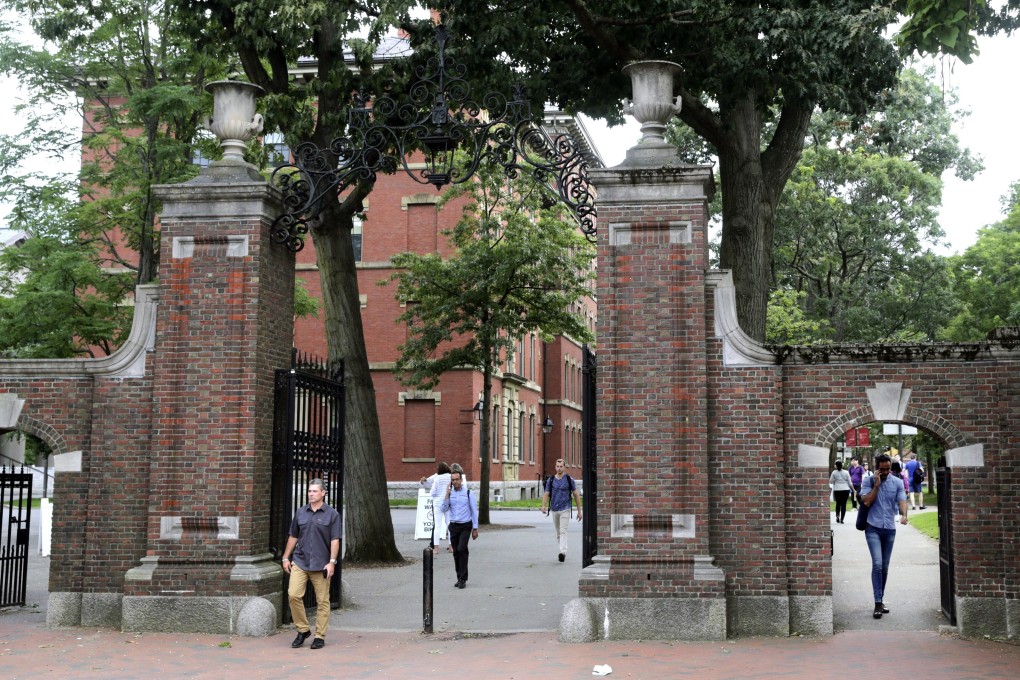 Pedestrians walk through the gates of Harvard Yard at Harvard University, which along with the Massachusetts Institute of Technology has filed a federal lawsuit challenging the new rule on online classes. Photo: AP