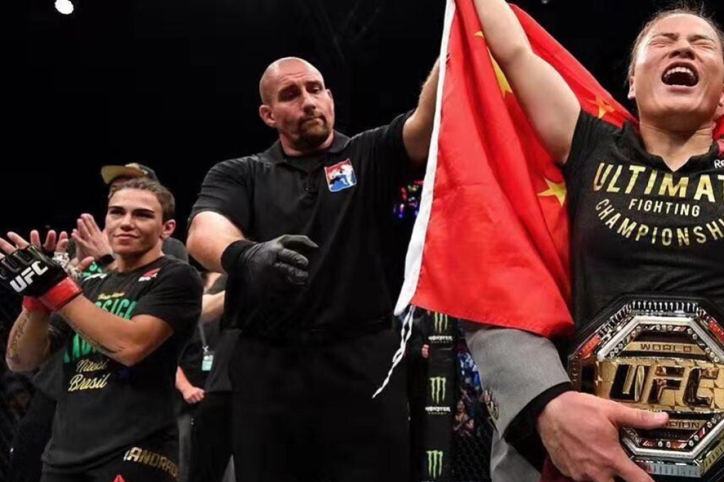 Zhang Weili celebrates her win as Jessica Andrade looks on. Photo: Brandon Magnus/Zuffa LLC