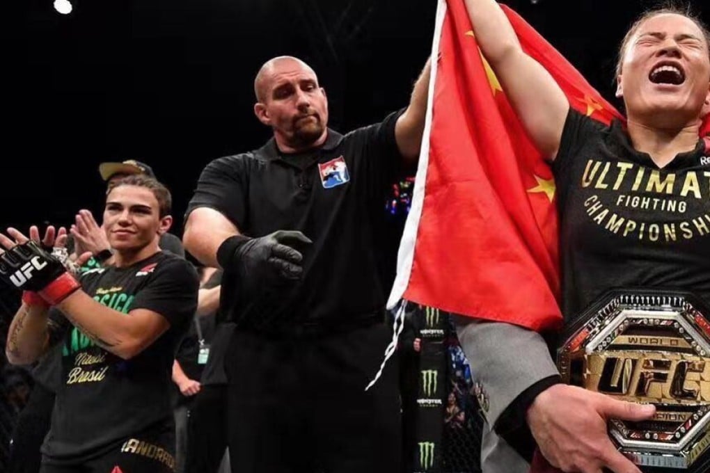 Zhang Weili celebrates her win as Jessica Andrade looks on. Photo: Brandon Magnus/Zuffa LLC