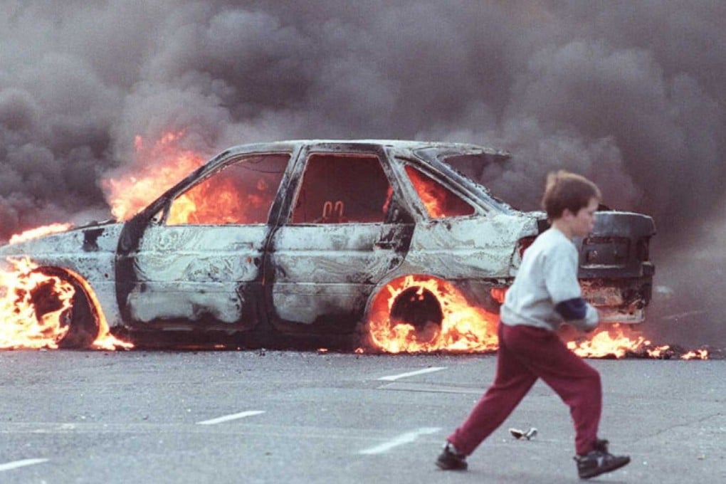 A burning car in the Catholic area of Shortstrand during the Troubles in Belfast in 1996. Photo: AFP