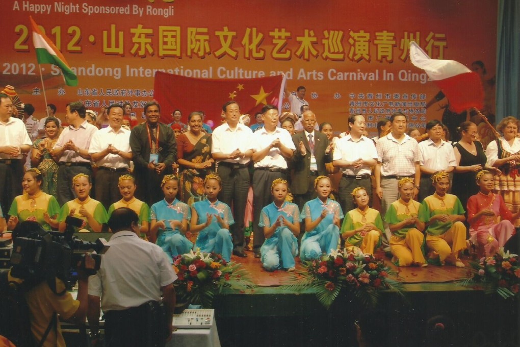 Bhaskaran, in grey suit, during a 2012 visit to China.