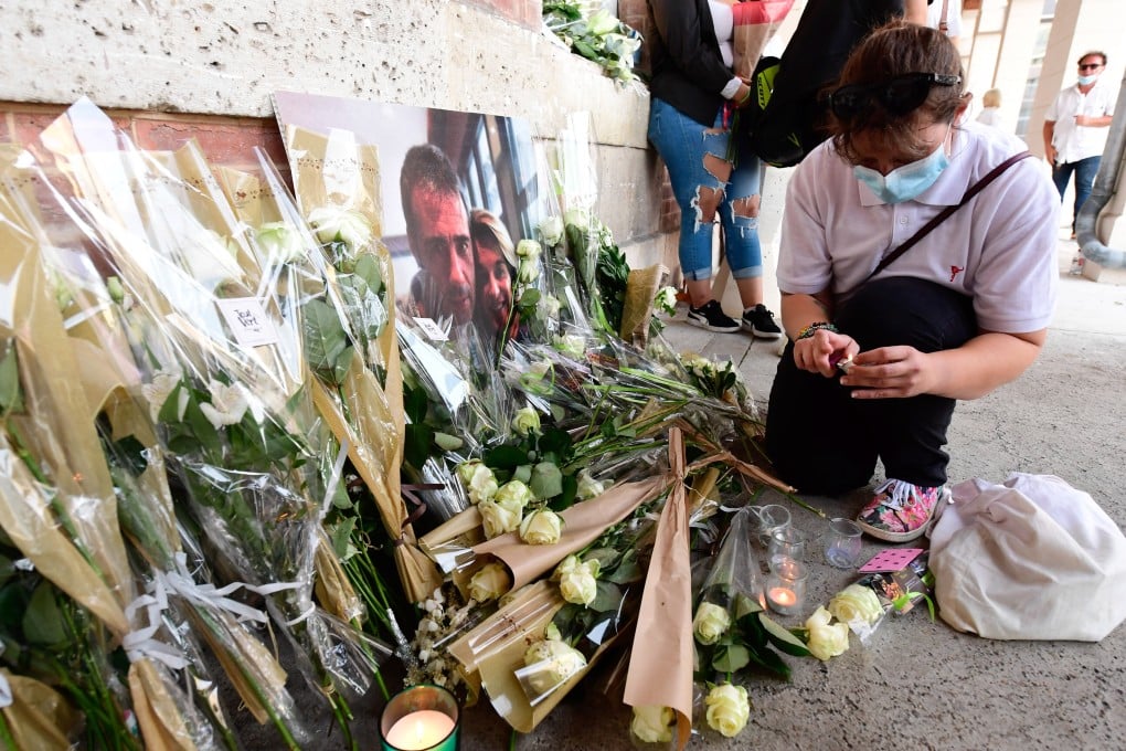 People leave flowers as thousands of people take part in a remembrance march in tribute to French bus driver Philippe Monguillot. Photo: EPA